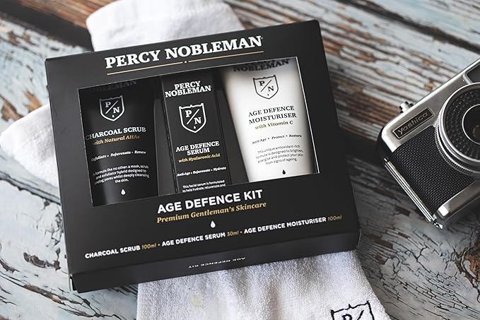 Age Defence Kit, a men's skincare set containing Charcoal Face Scrub (with Natural AHAs), ultra-hydrating Facial Serum (with Hyaluronic Acid), and Moisturiser (with Vitamin C)